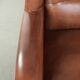Large sheepskin wingback armchair in timeless English style