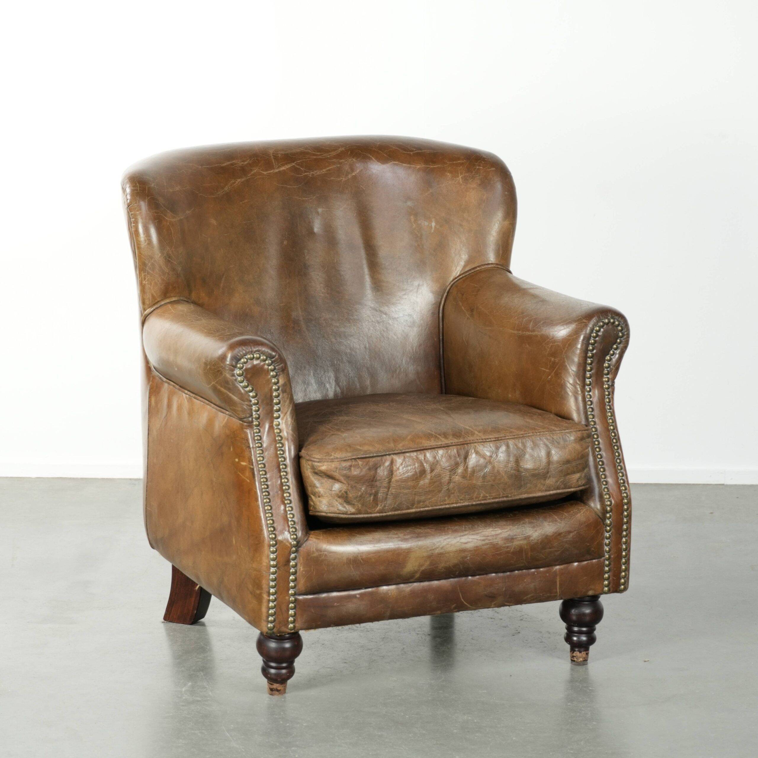 Robust cowhide armchair in a beautifully subtle size with a wonderful patina.