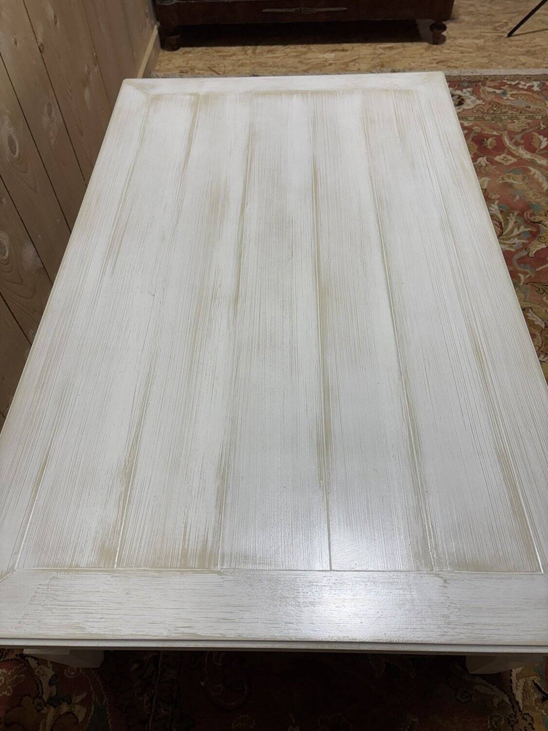 Painted wood coffee table with a distressed finish.