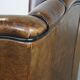 Vintage sheepskin wingback chair finished with black piping