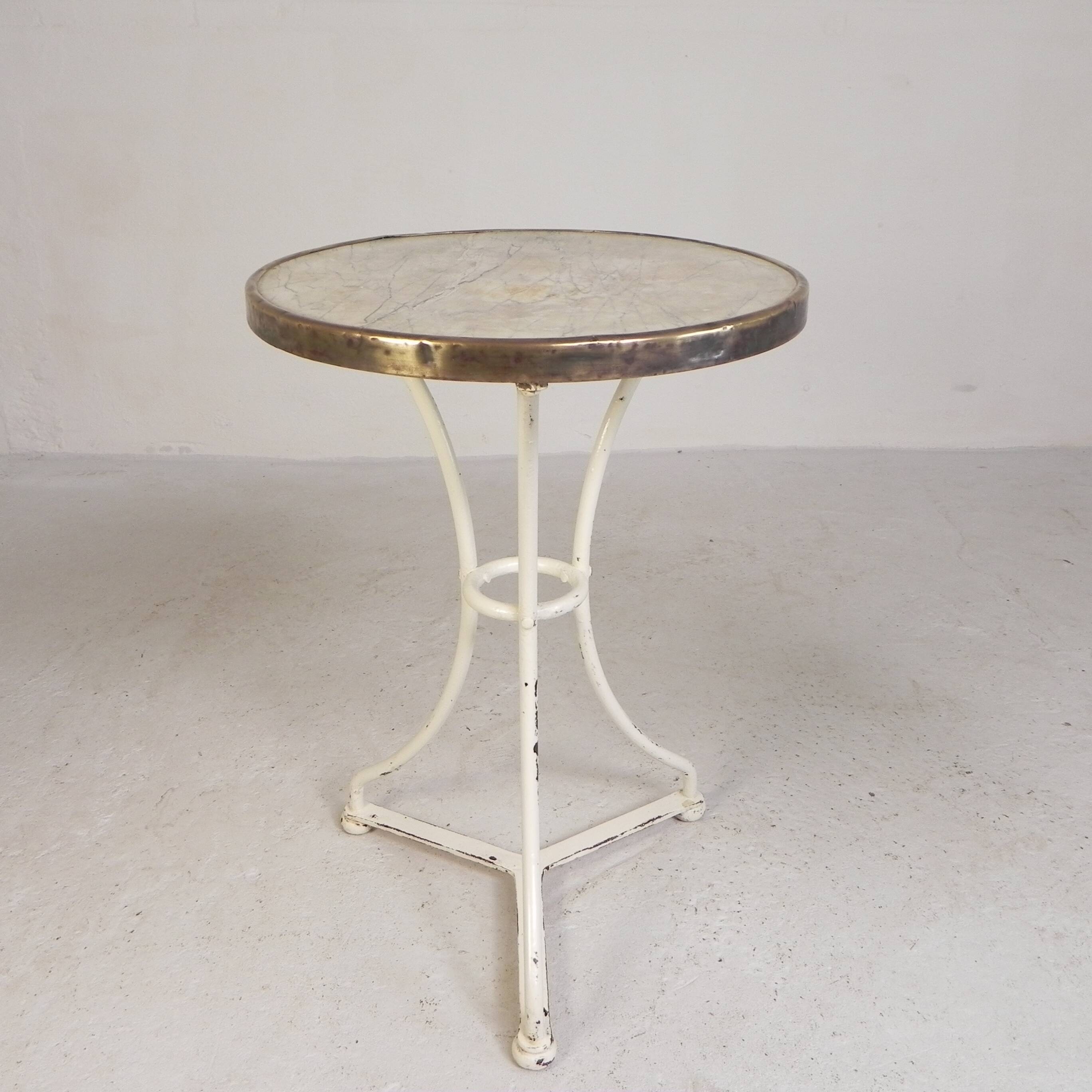 Bistro table with a marble top and brass edging, early 20th century.