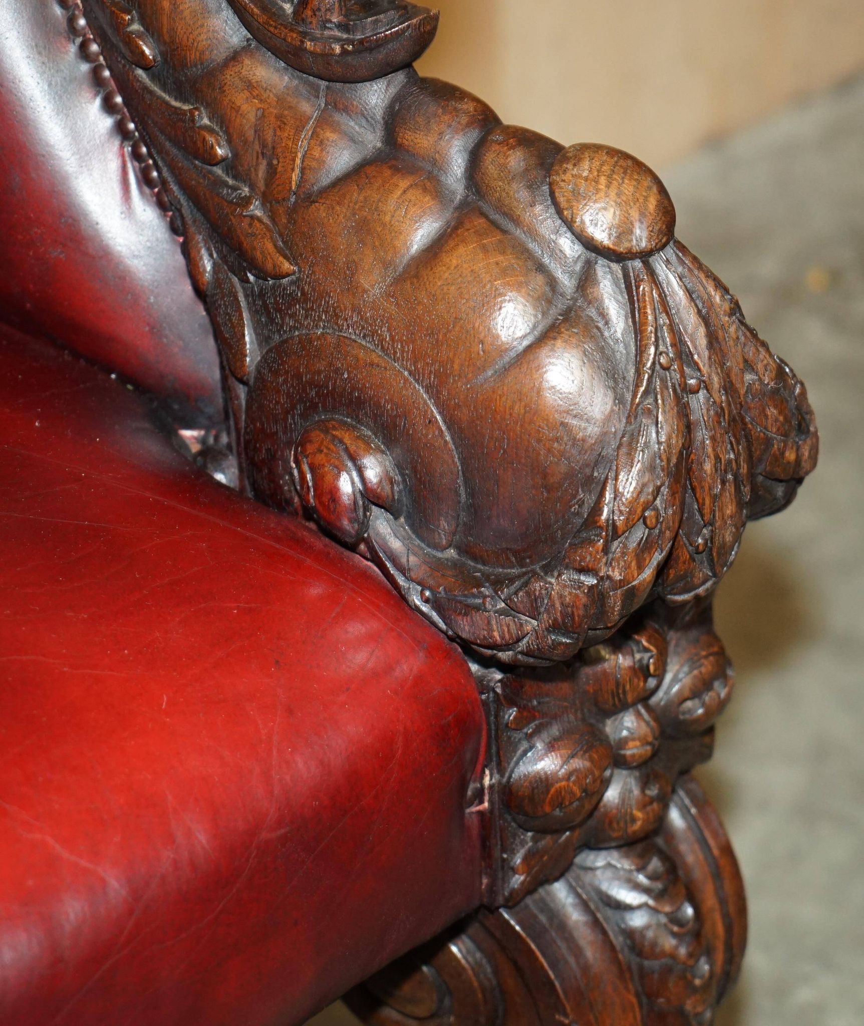 Victorian Chesterfield leather sofa with carved lion heads.