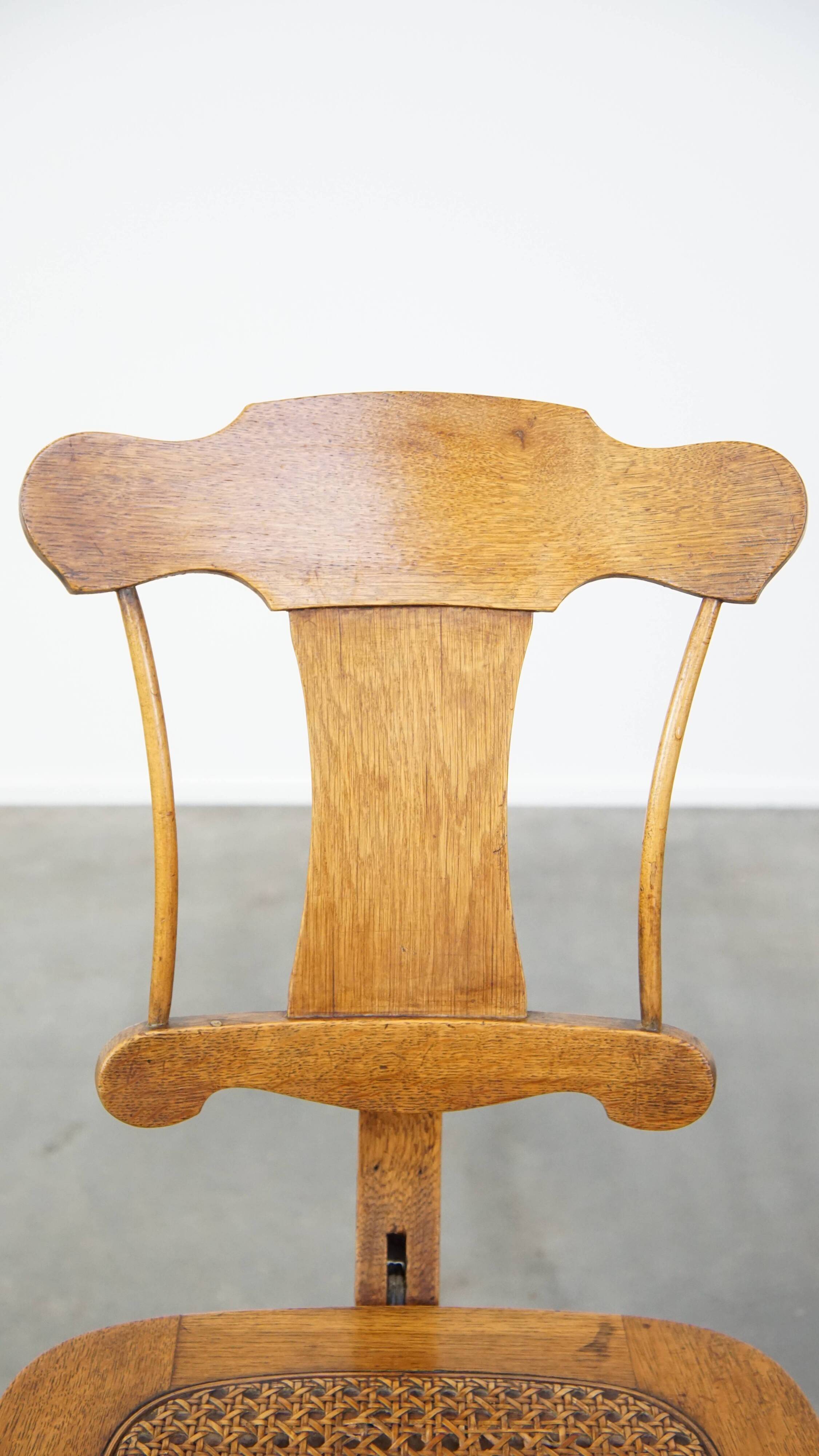 Antique late 19th century English office chair with reclining backrest and height adjustable