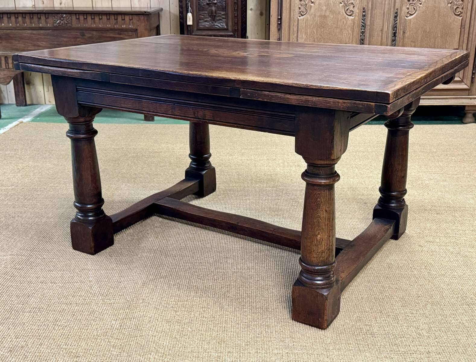 English monastery table with extensions from the late 19th century in elm and oak.