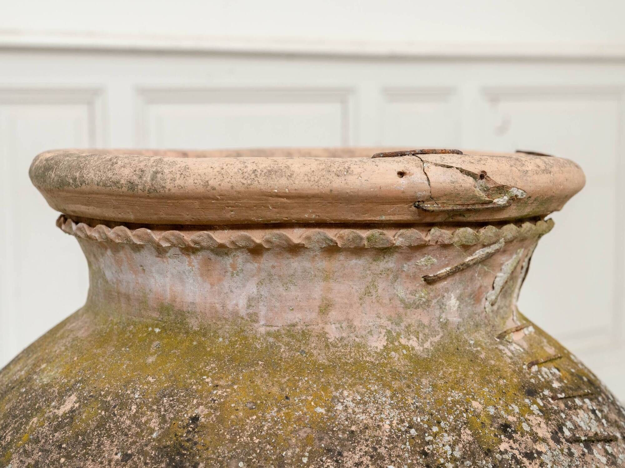 Old terracotta jar with its metal clasps, late 19th century.