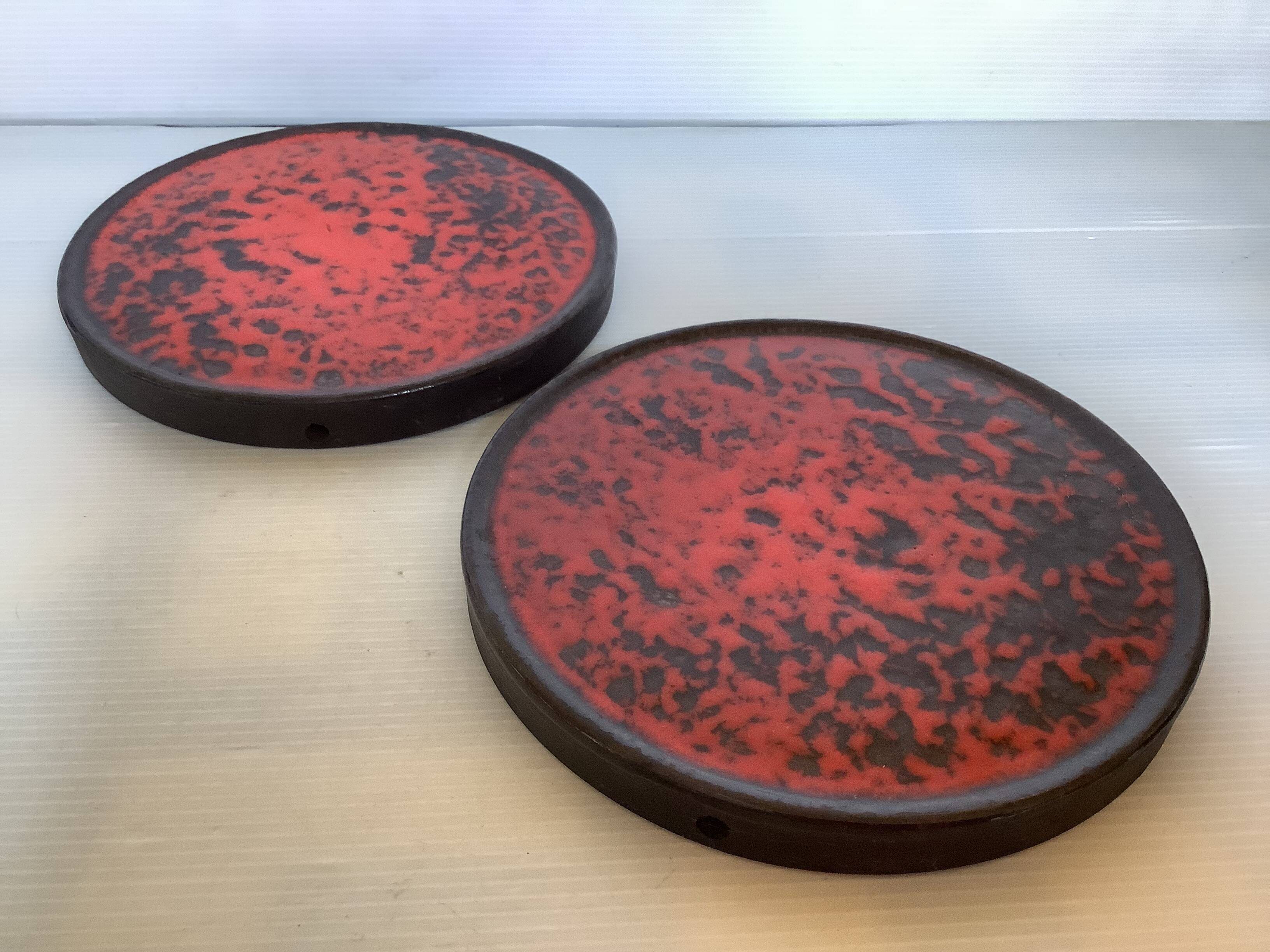 Pair of red speckled ceramic trivets