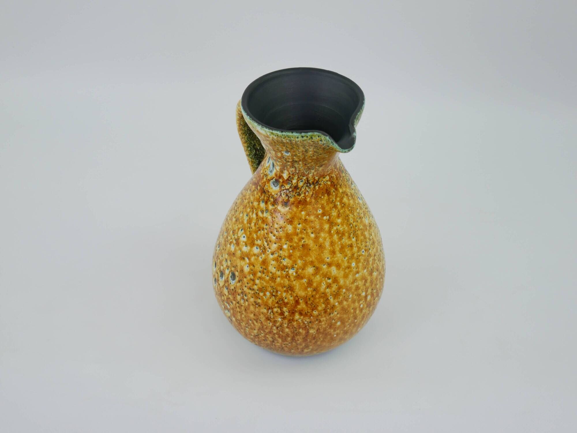 Large yellow ceramic pitcher in the Accolay style