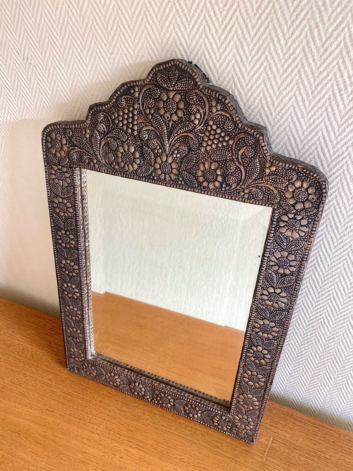Ancient oriental mirror in embossed copper