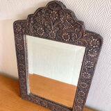 Ancient oriental mirror in embossed copper