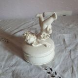 Small round box topped with a vintage biscuit porcelain angel