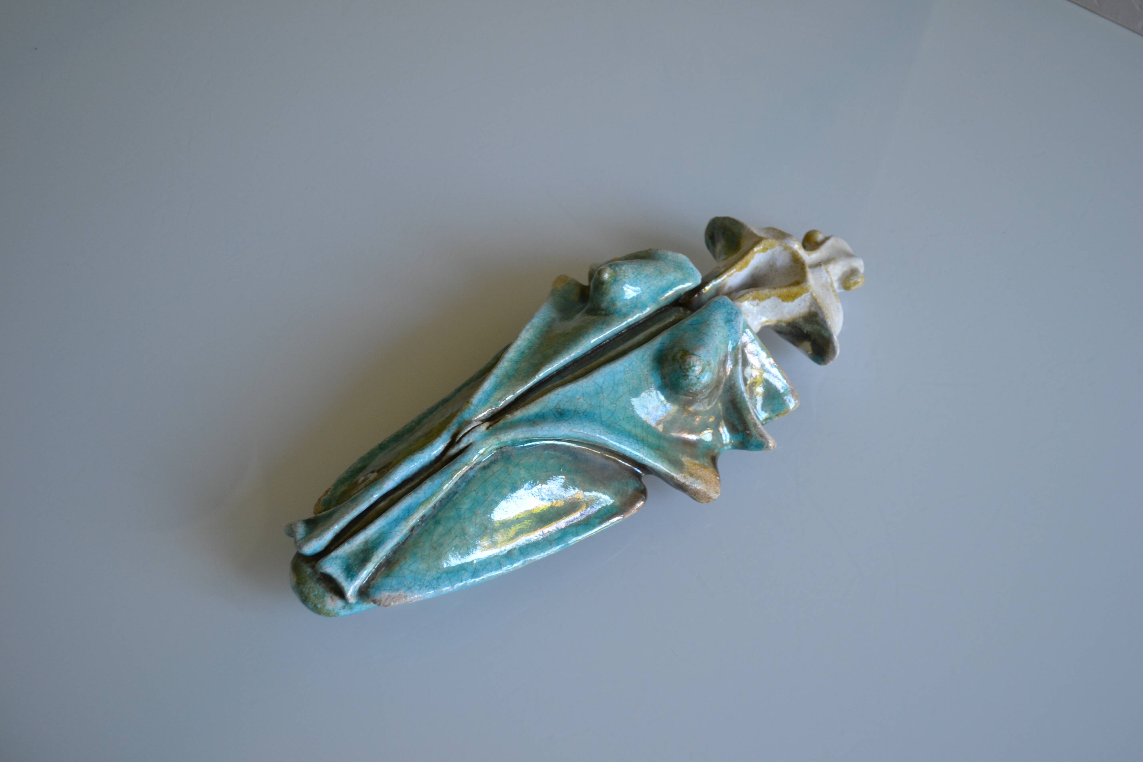 Surreal ceramic sculpture in relief signed to be identified.