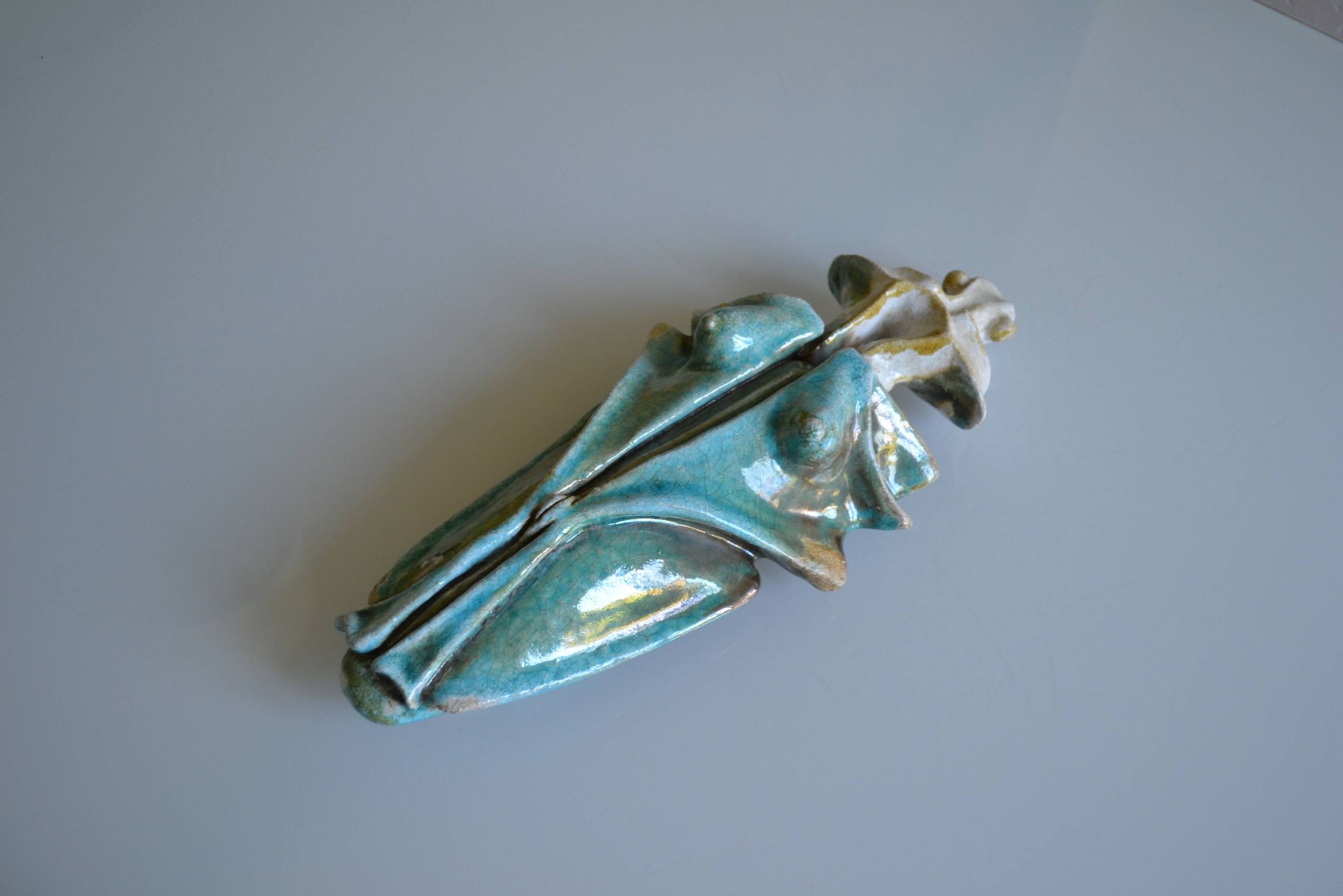 Surreal ceramic sculpture in relief signed to be identified.