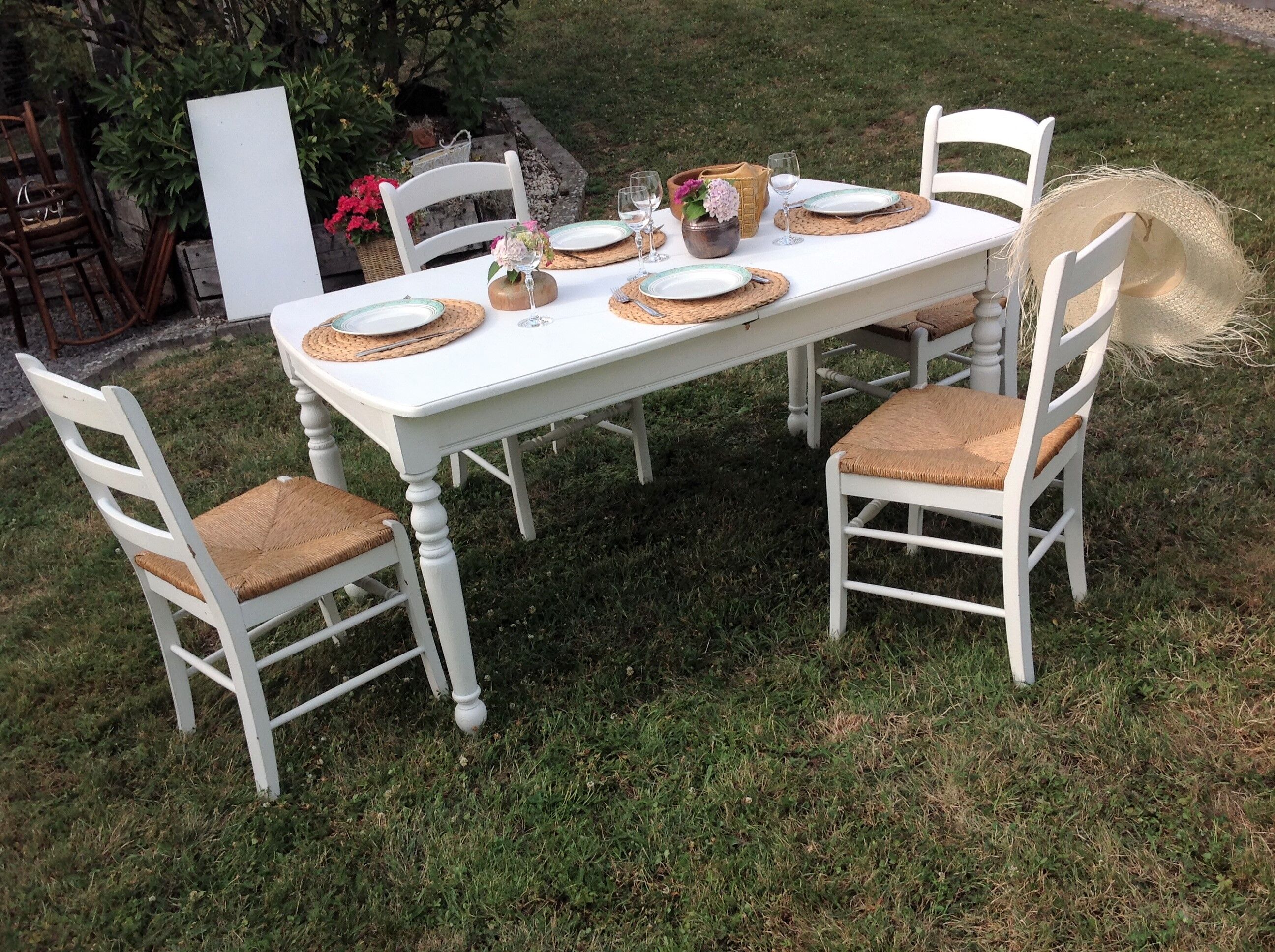White farmhouse table set and four chairs