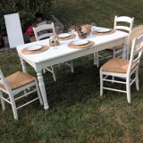 White farmhouse table set and four chairs