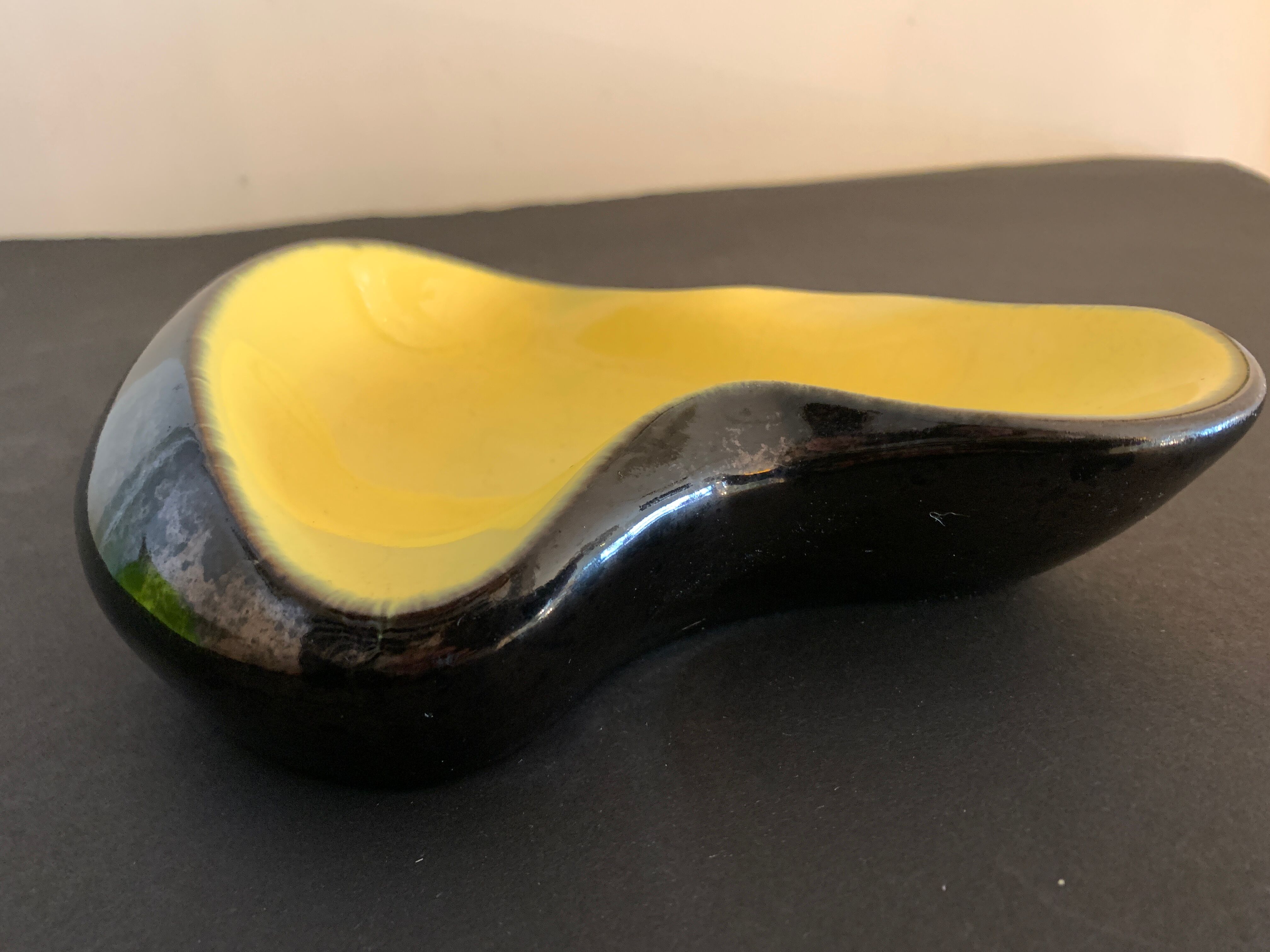Yellow and black ceramic ashtray