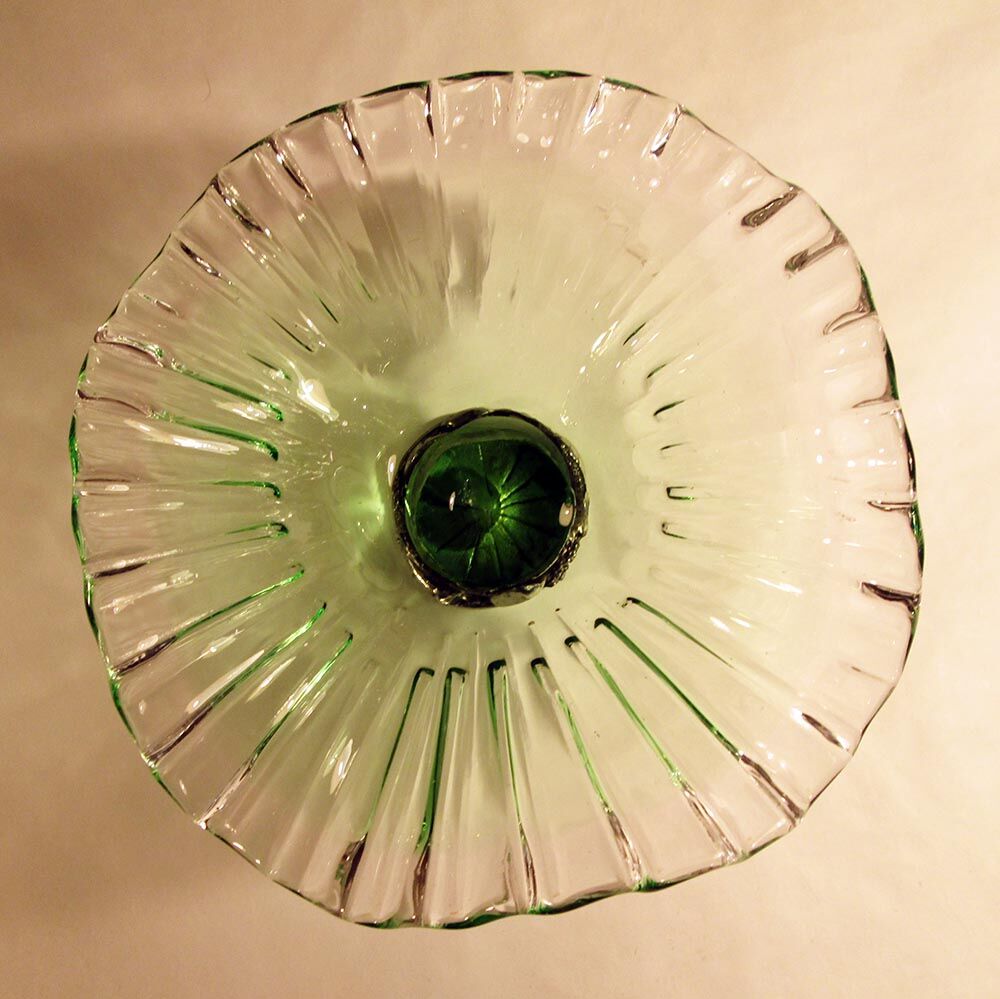 Glass cup on decorated metal stand