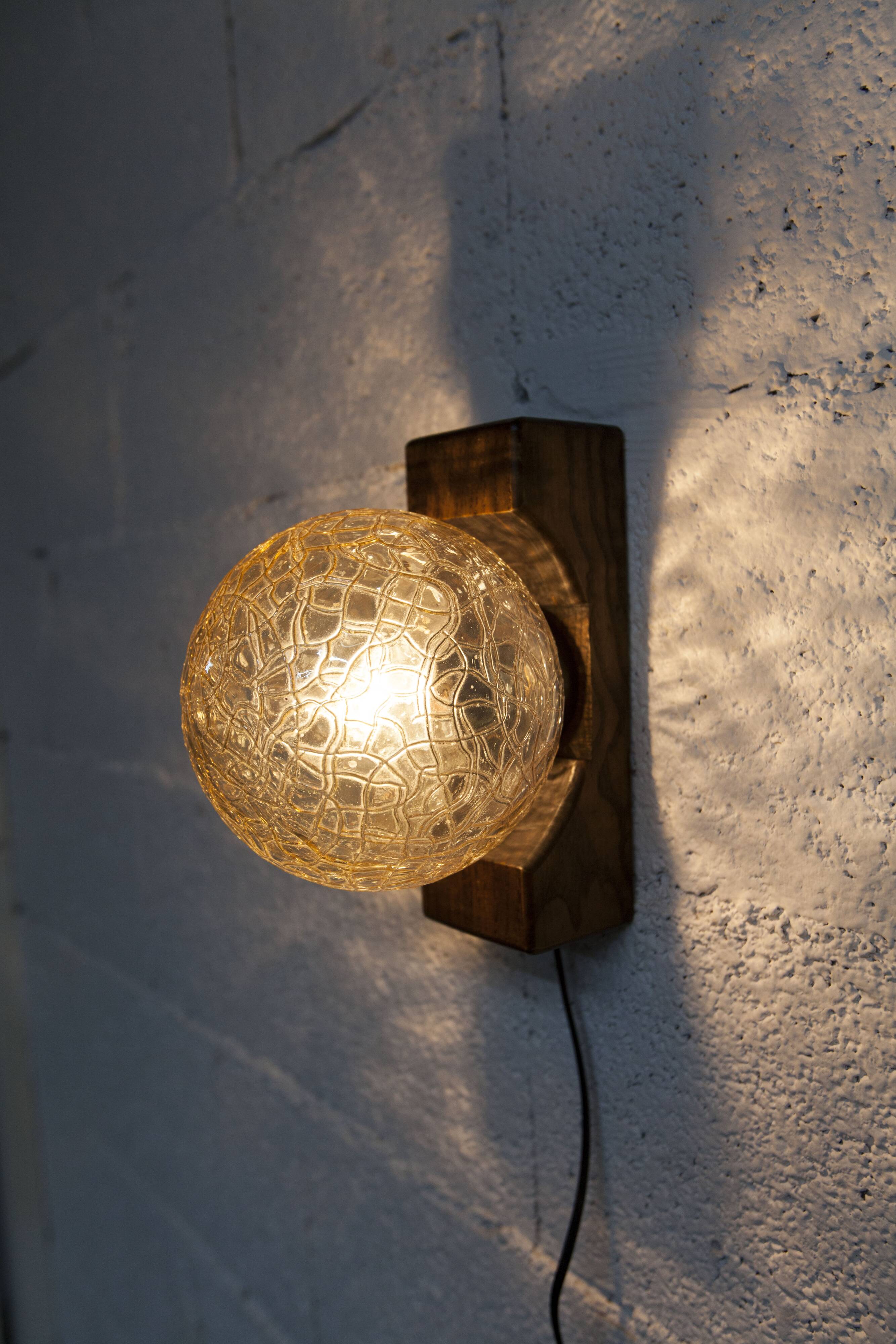 1960s ball wall light in dark wood and amber glass