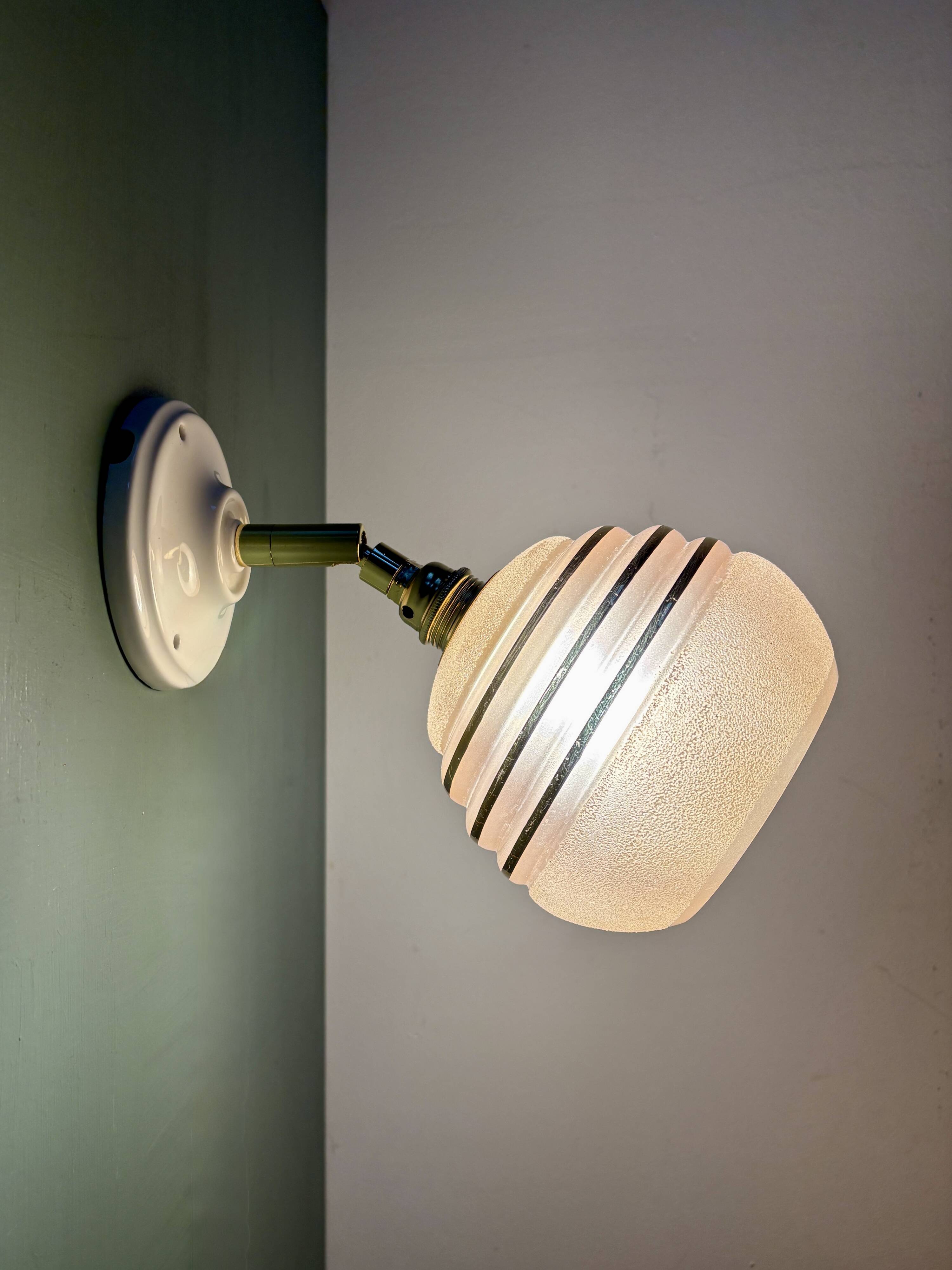 Vintage globe wall light in frosted pink and gold glass.