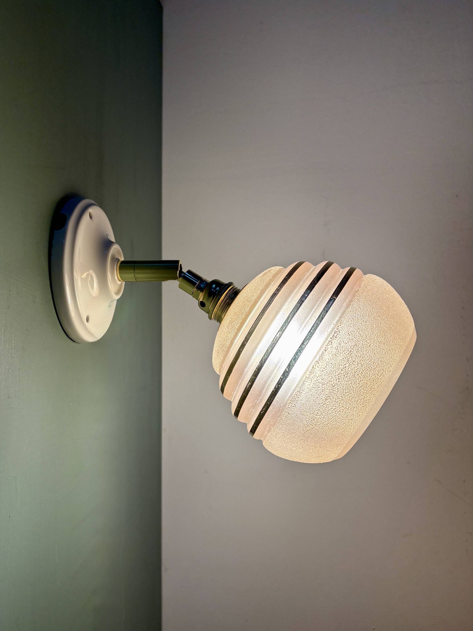 Vintage globe wall light in frosted pink and gold glass.
