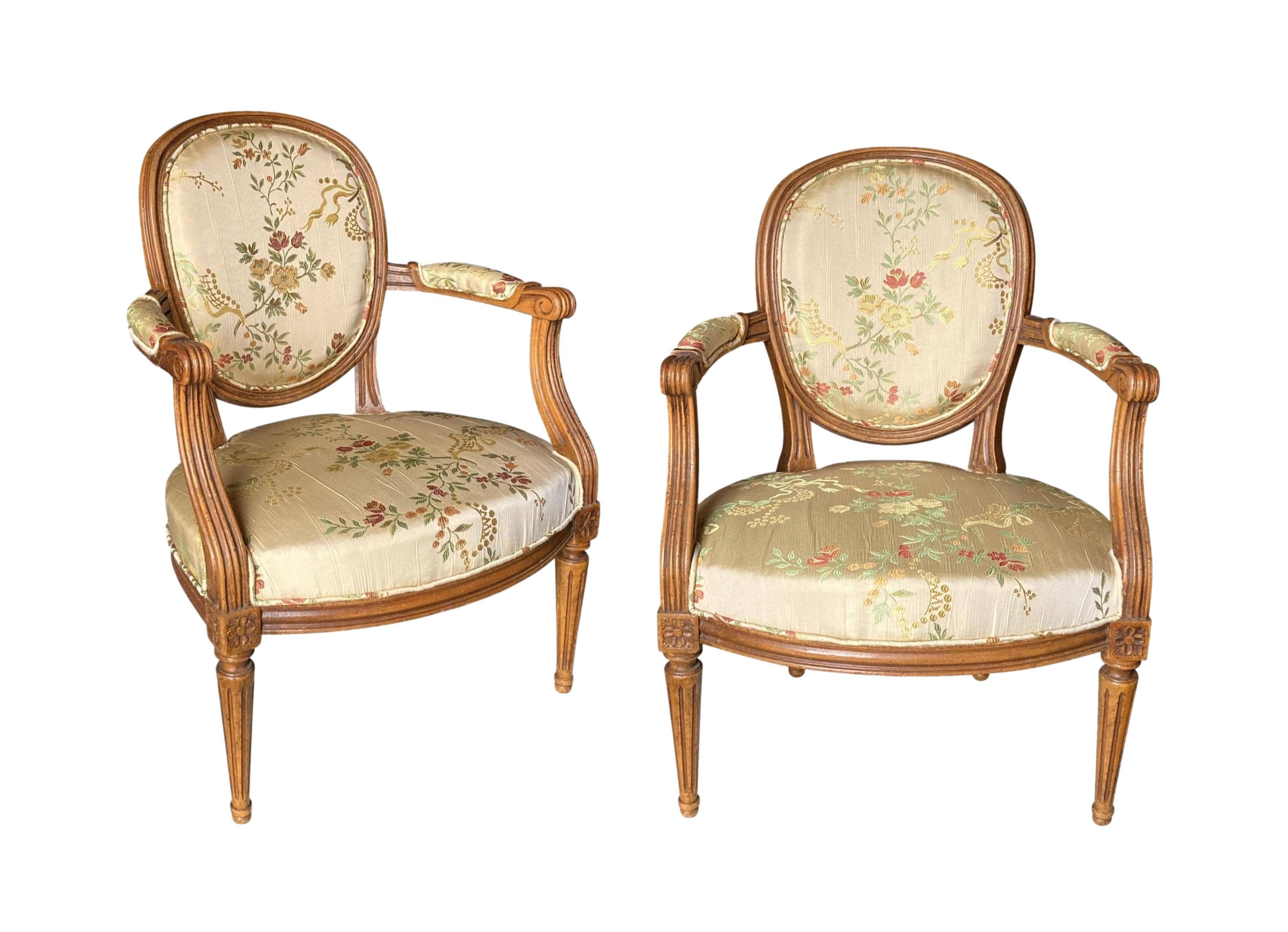 Pair of Louis XVI silk cabriolet armchairs