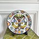 Decorative ceramic plate with griffins