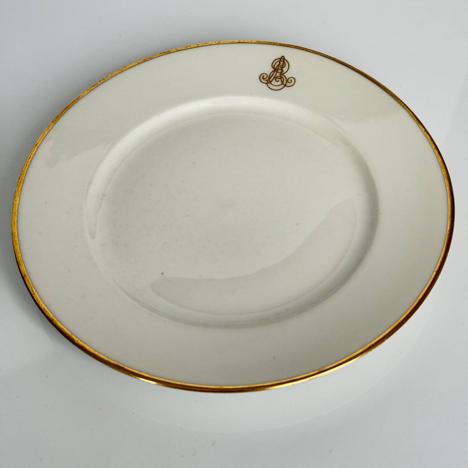 Set of monogrammed plates with gilt edges | E. Bourgeois | Late 19th century