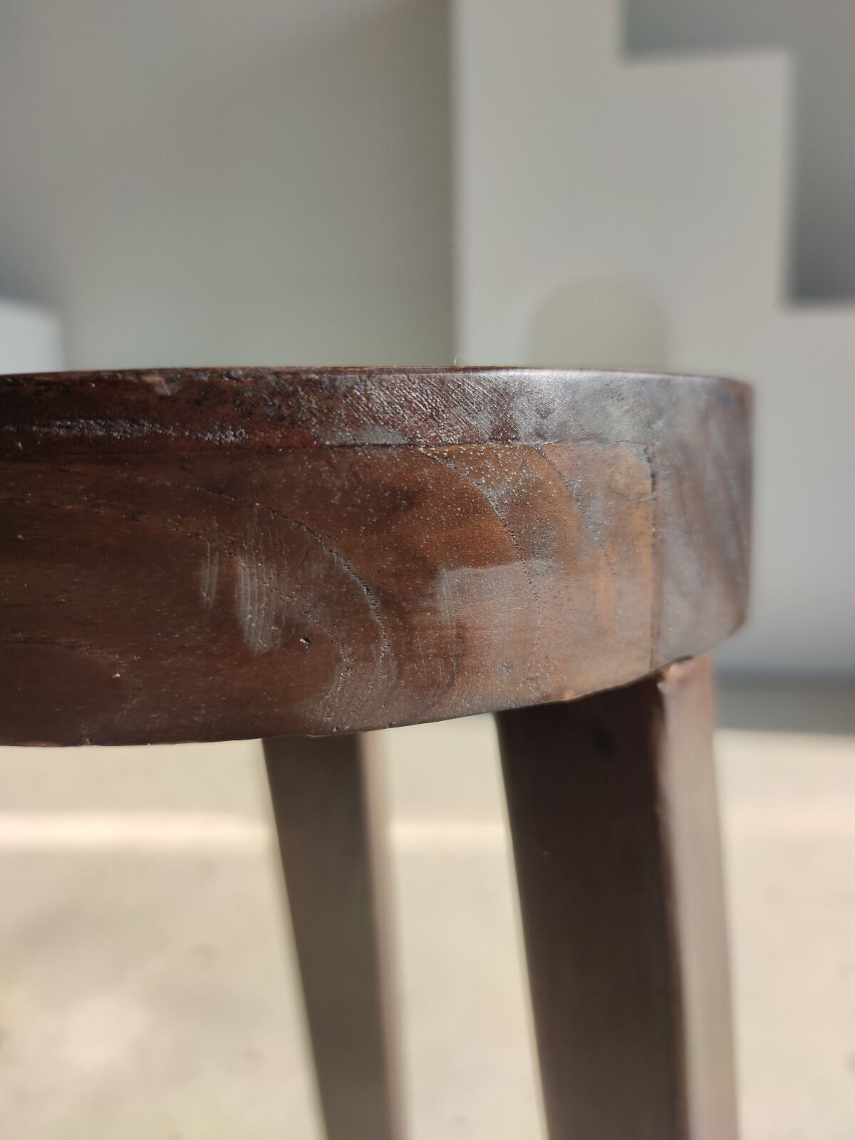 Small high tripod stool in brown solid wood