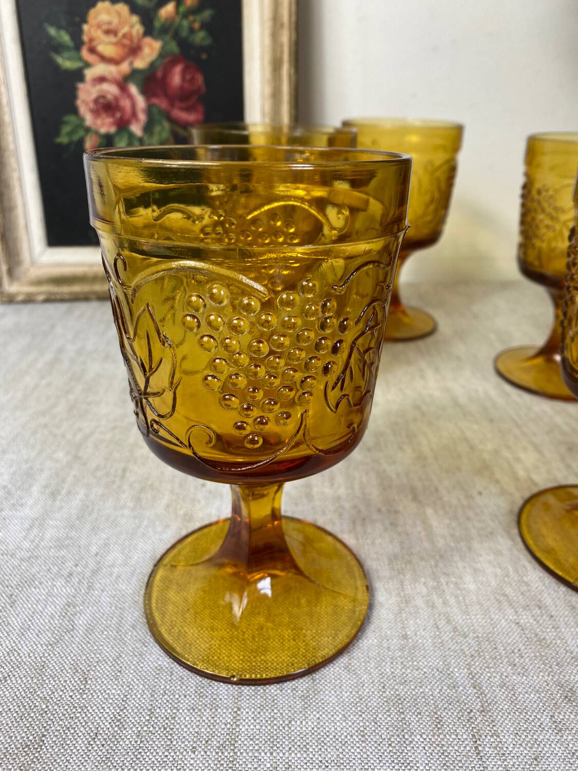 Six amber-colored stemmed glasses