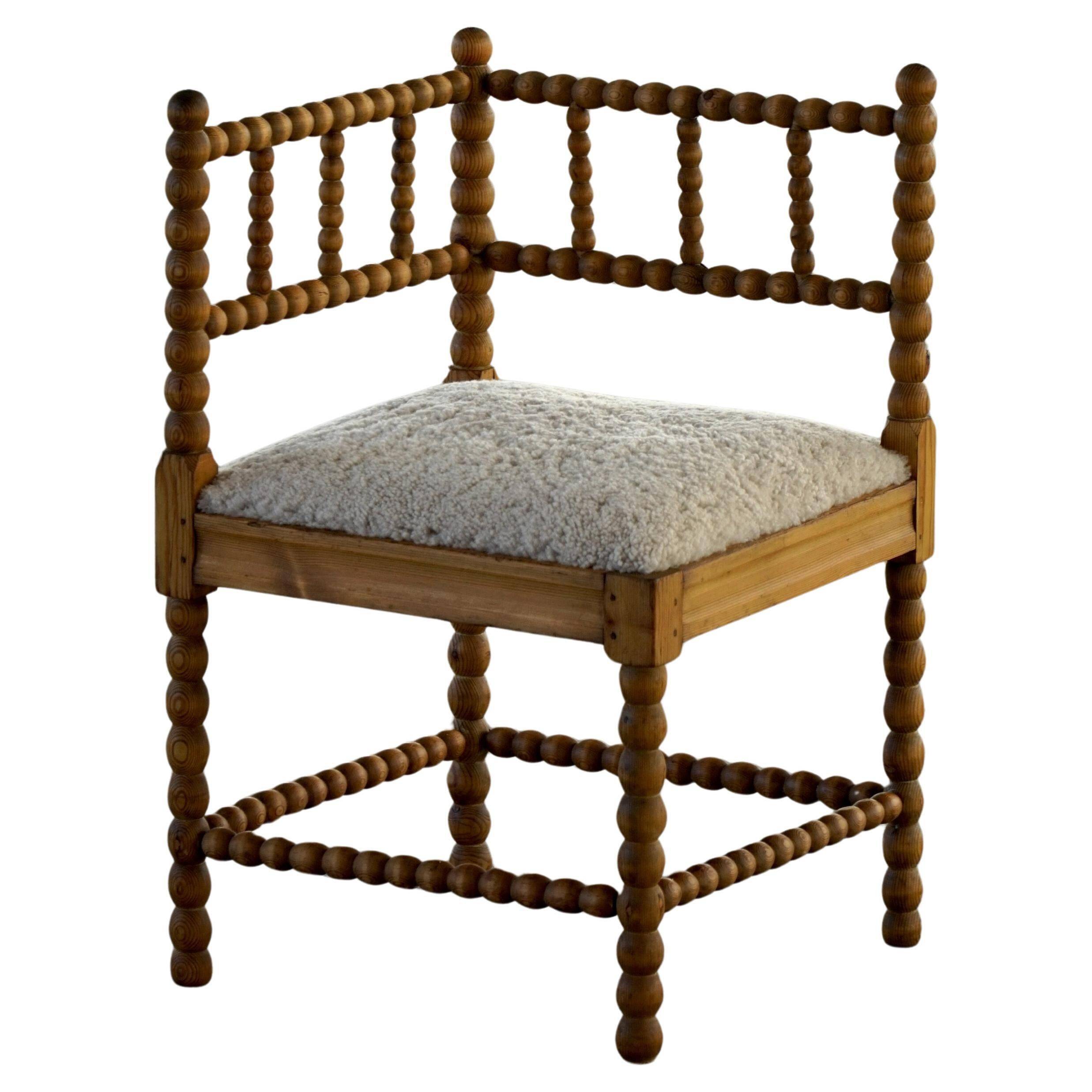 Antique French corner chair handcrafted with lamb's wool, early 20th century.