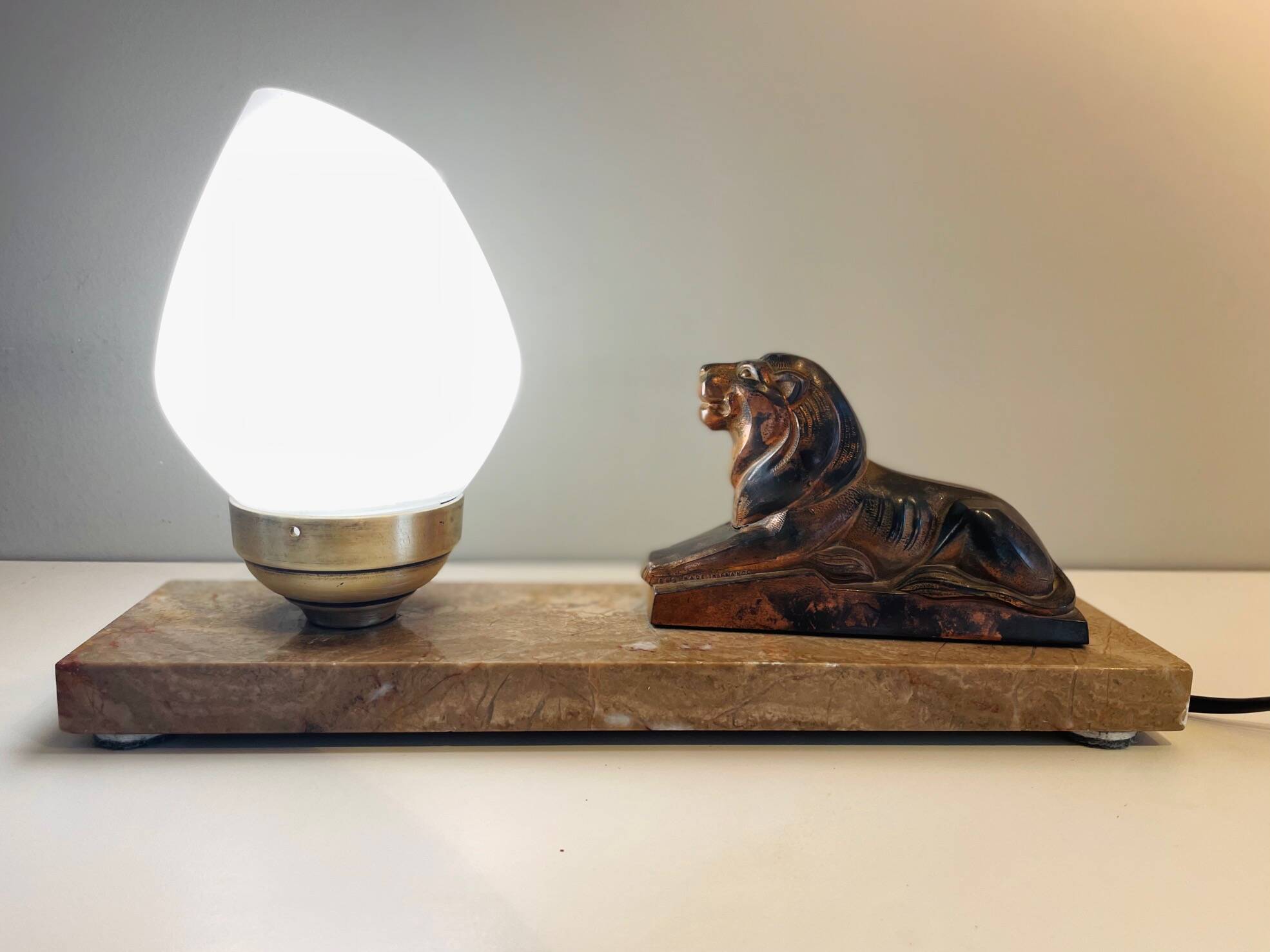 Art Deco lamp with marble, opaline globe & lion sculpture in spelter