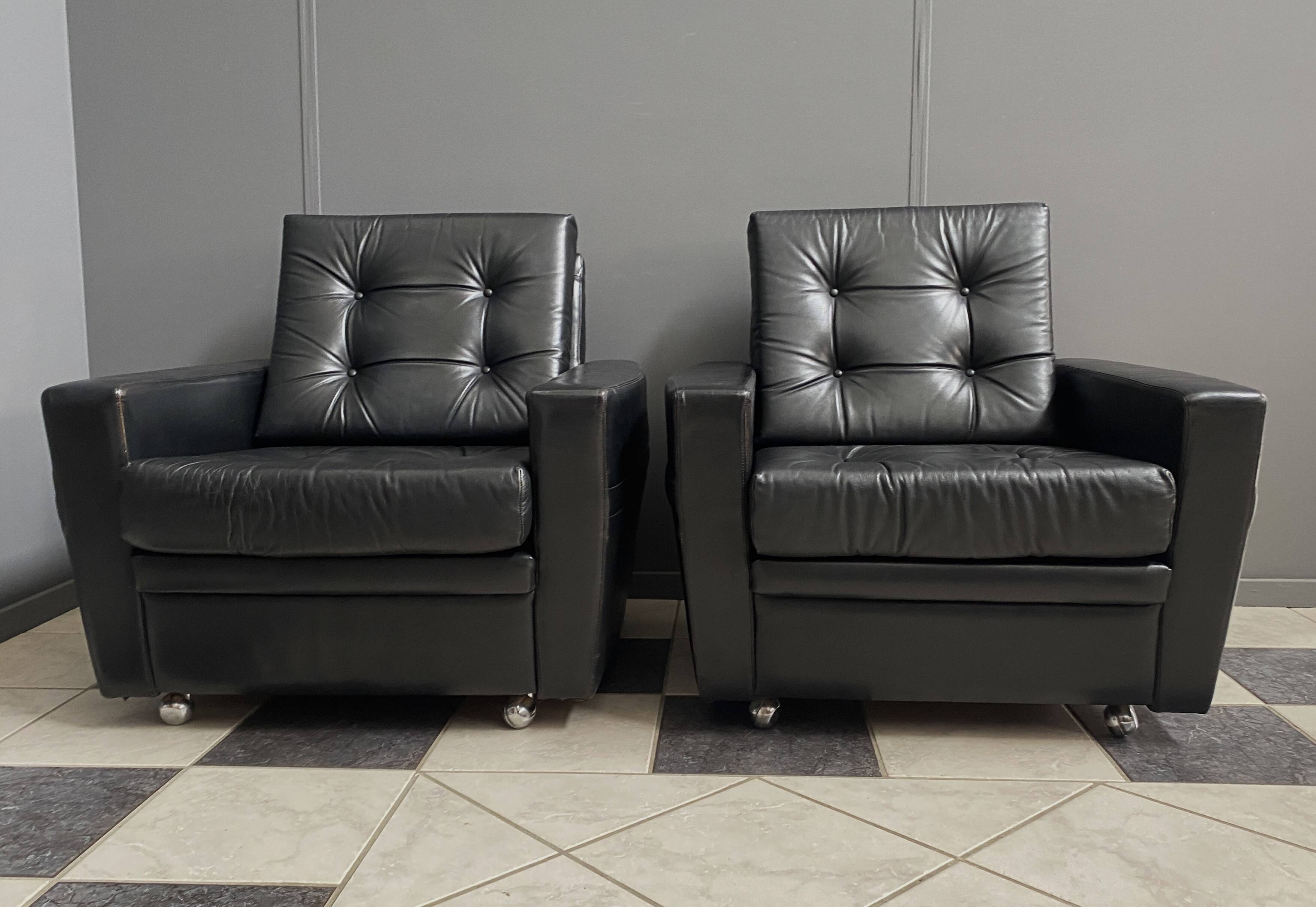 2 Black leather arm chairs 1960s on wheels