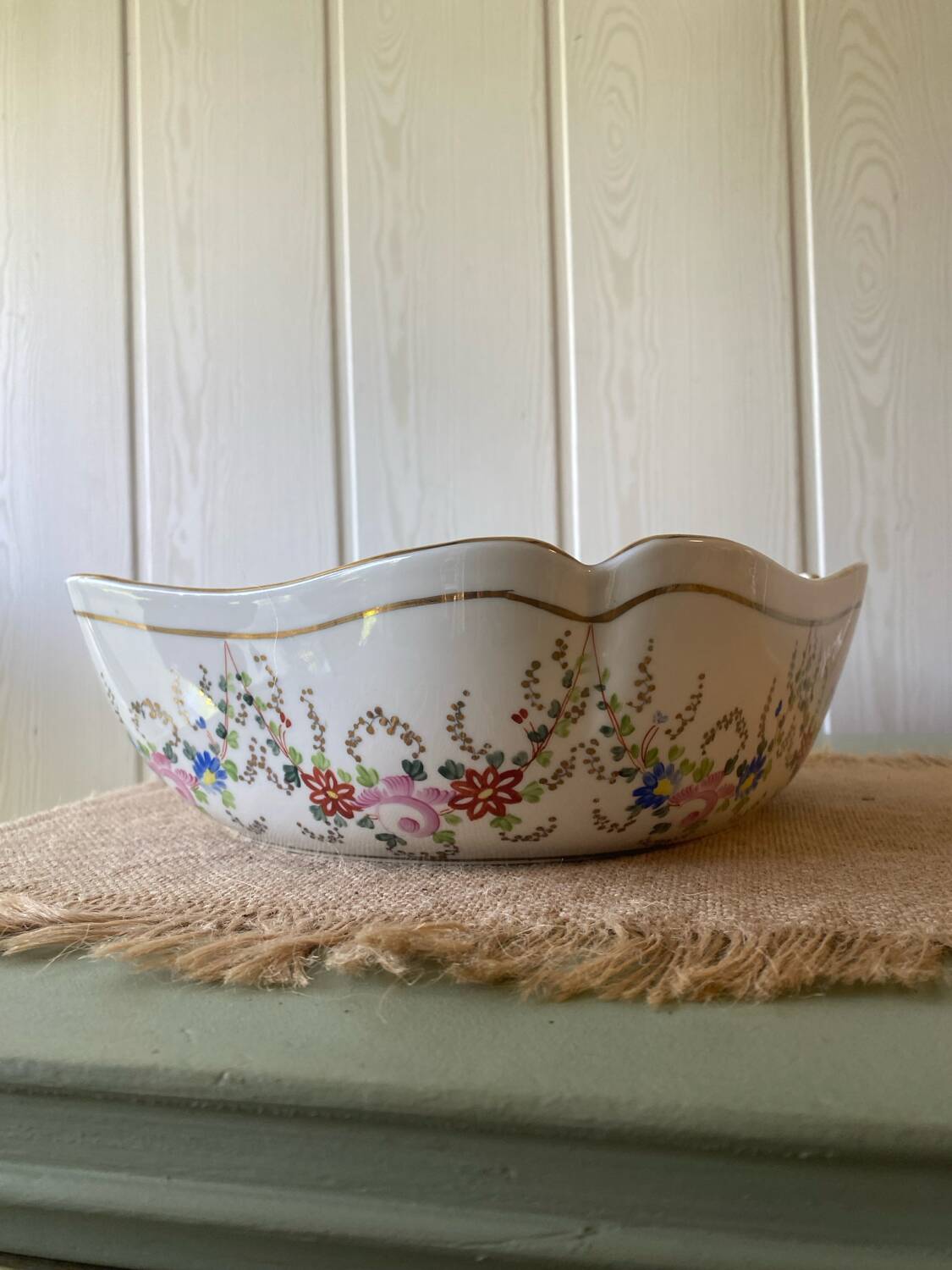 Old hollow porcelain dish with floral decoration and gold trim