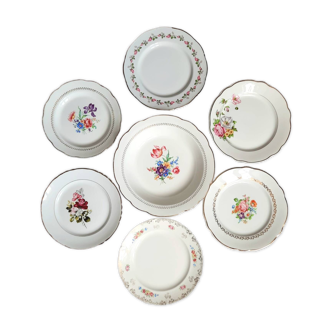 Old mismatched earthenware dinner plates with gold accompanied by a deep dish