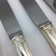 12 silver metal knives.