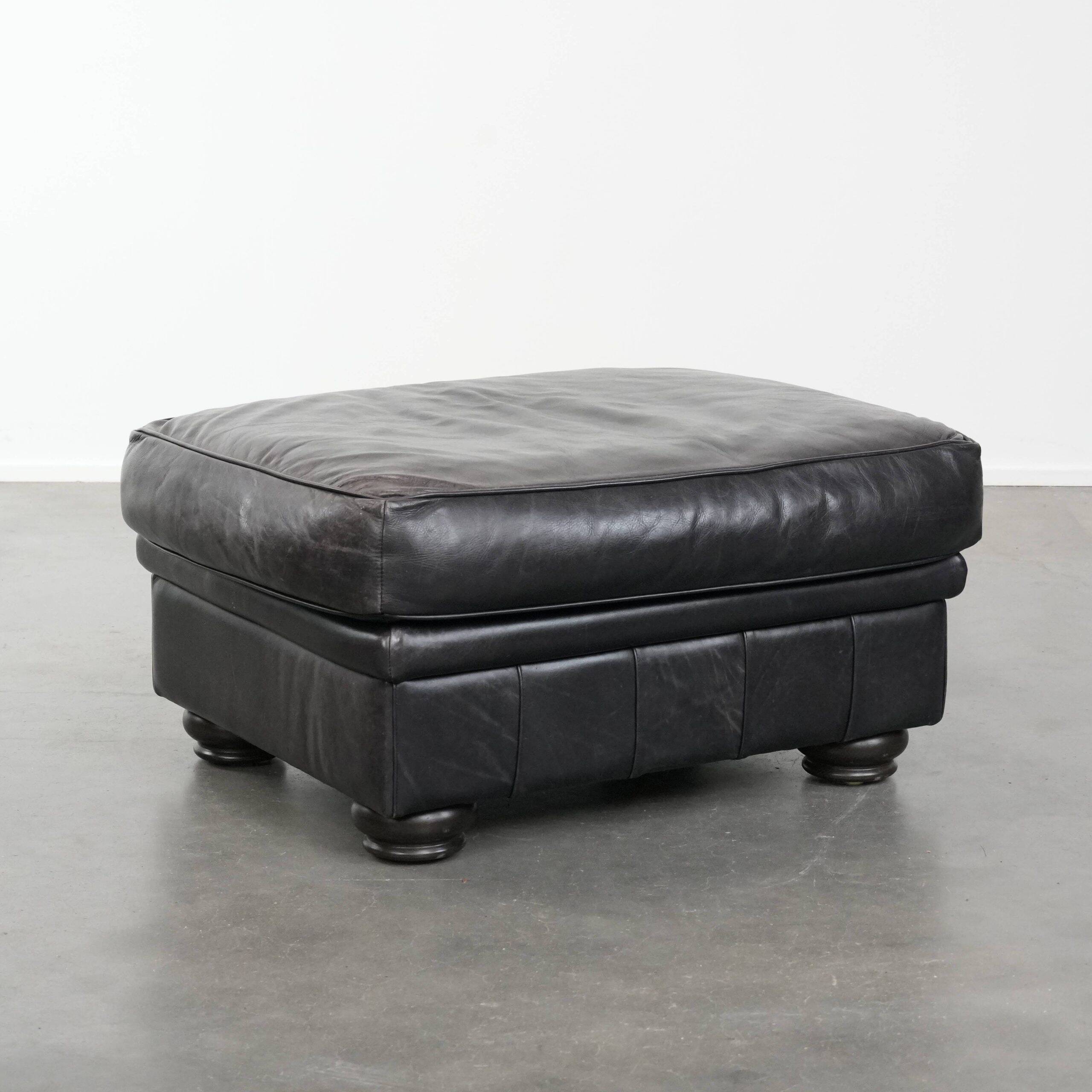Large and timeless black ottoman made of cowhide leather in English style