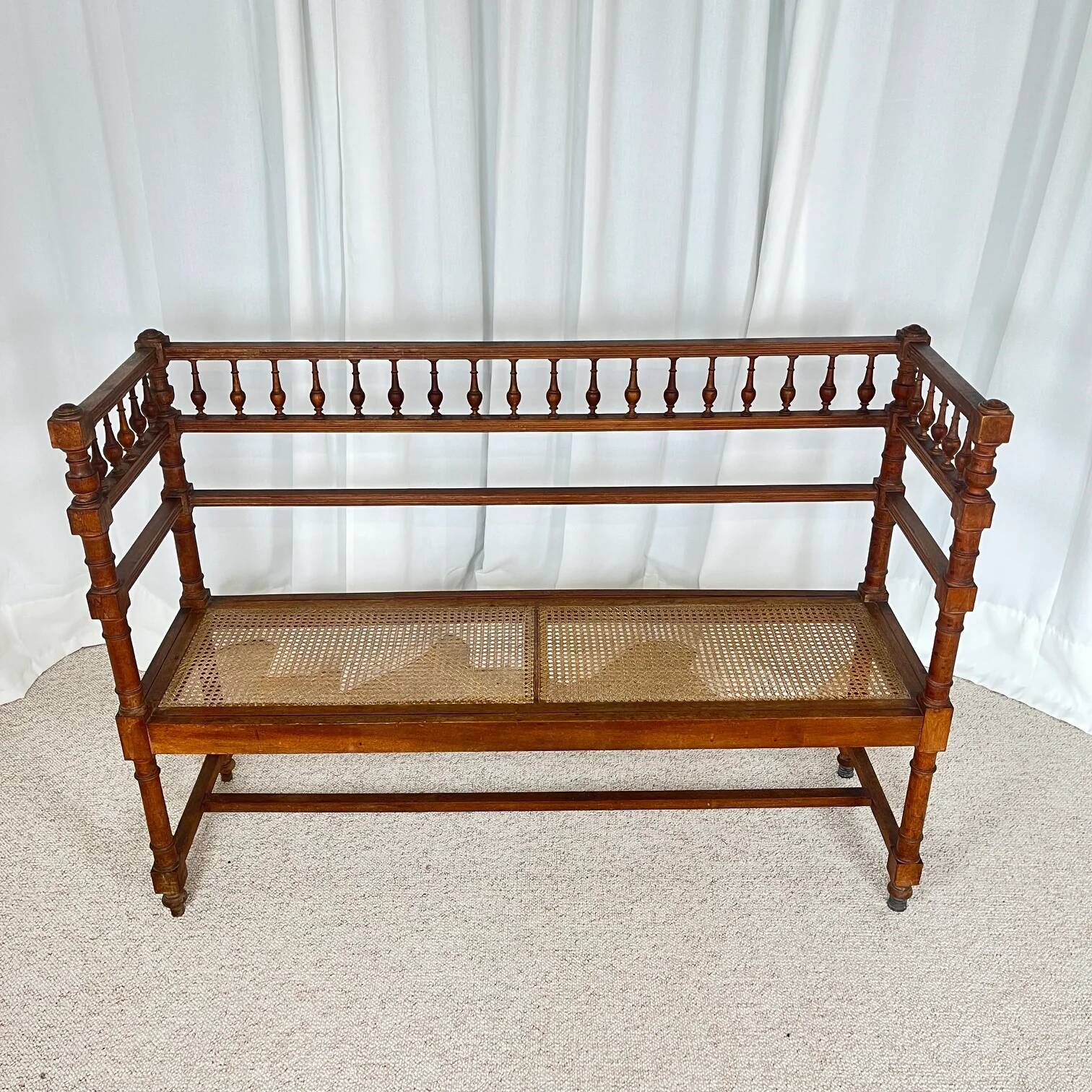 Antique banquette in Louis XIII style, turned wood with caning, late 19th to early 20th century.