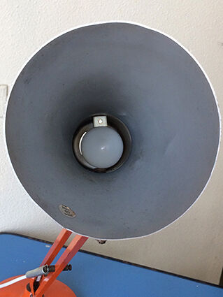 Luxo L9 orange single-arm lamp on plinth