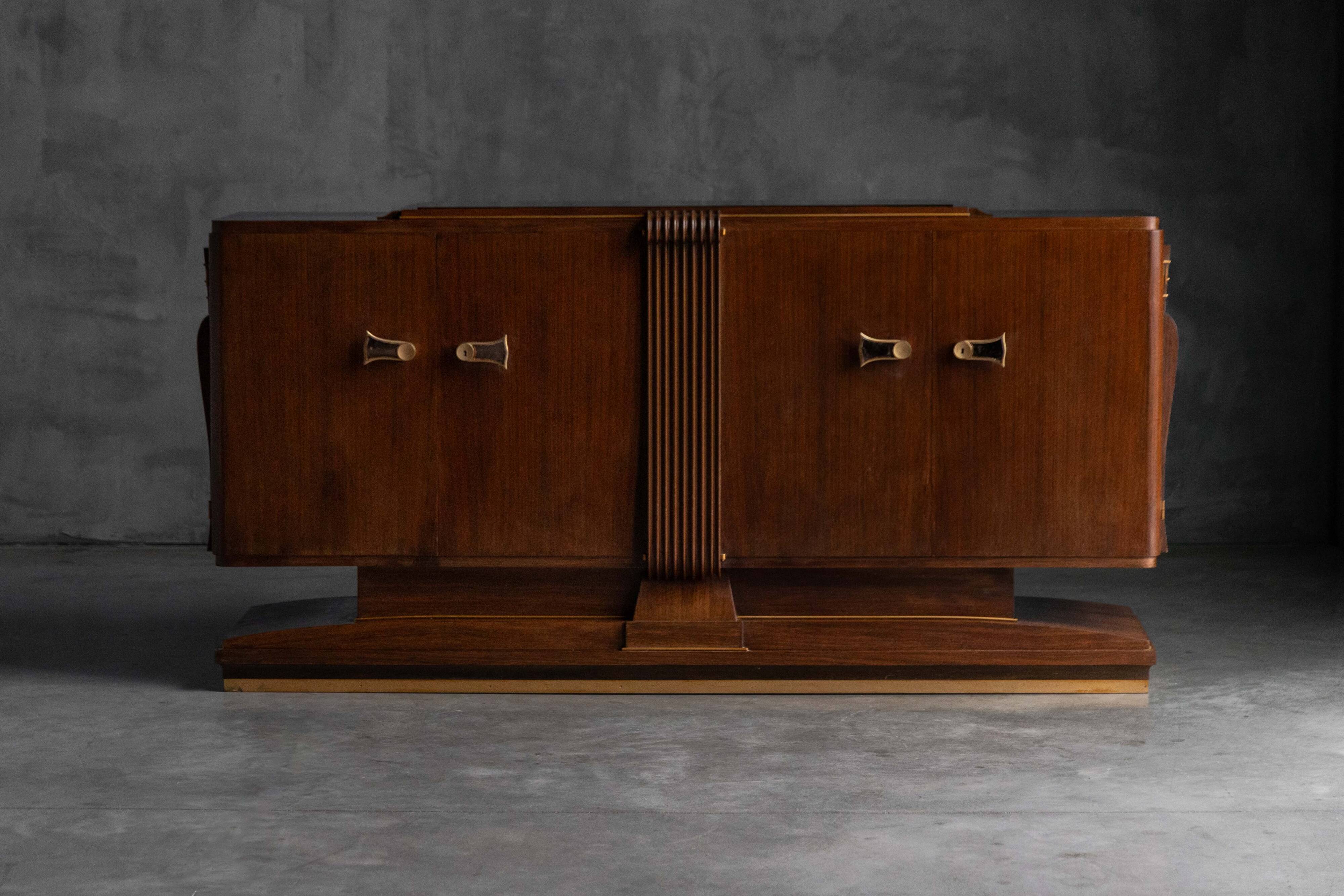 Art Deco walnut sideboard with brass details and sculptural base, France, 1930s