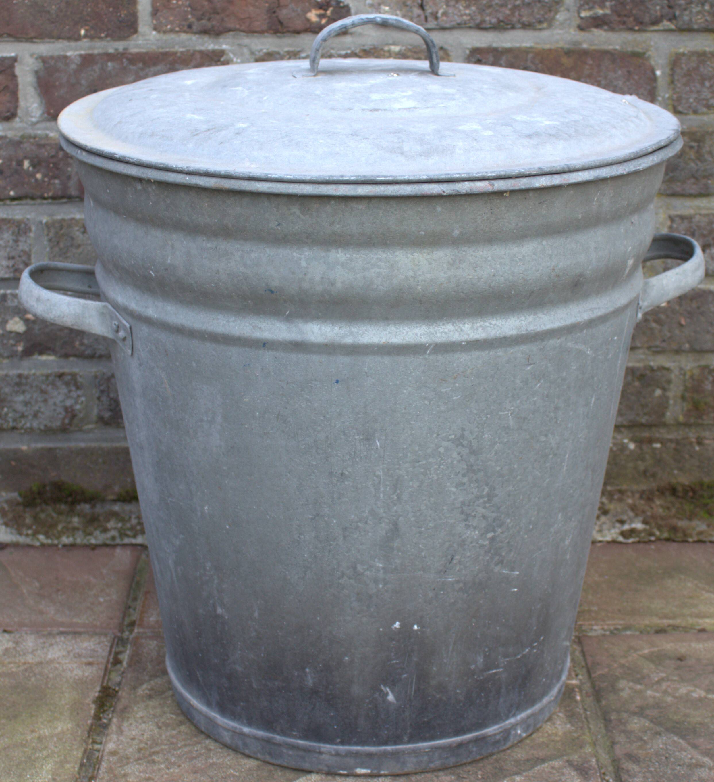 Old galvanized zinc trash can with lid