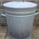 Old galvanized zinc trash can with lid