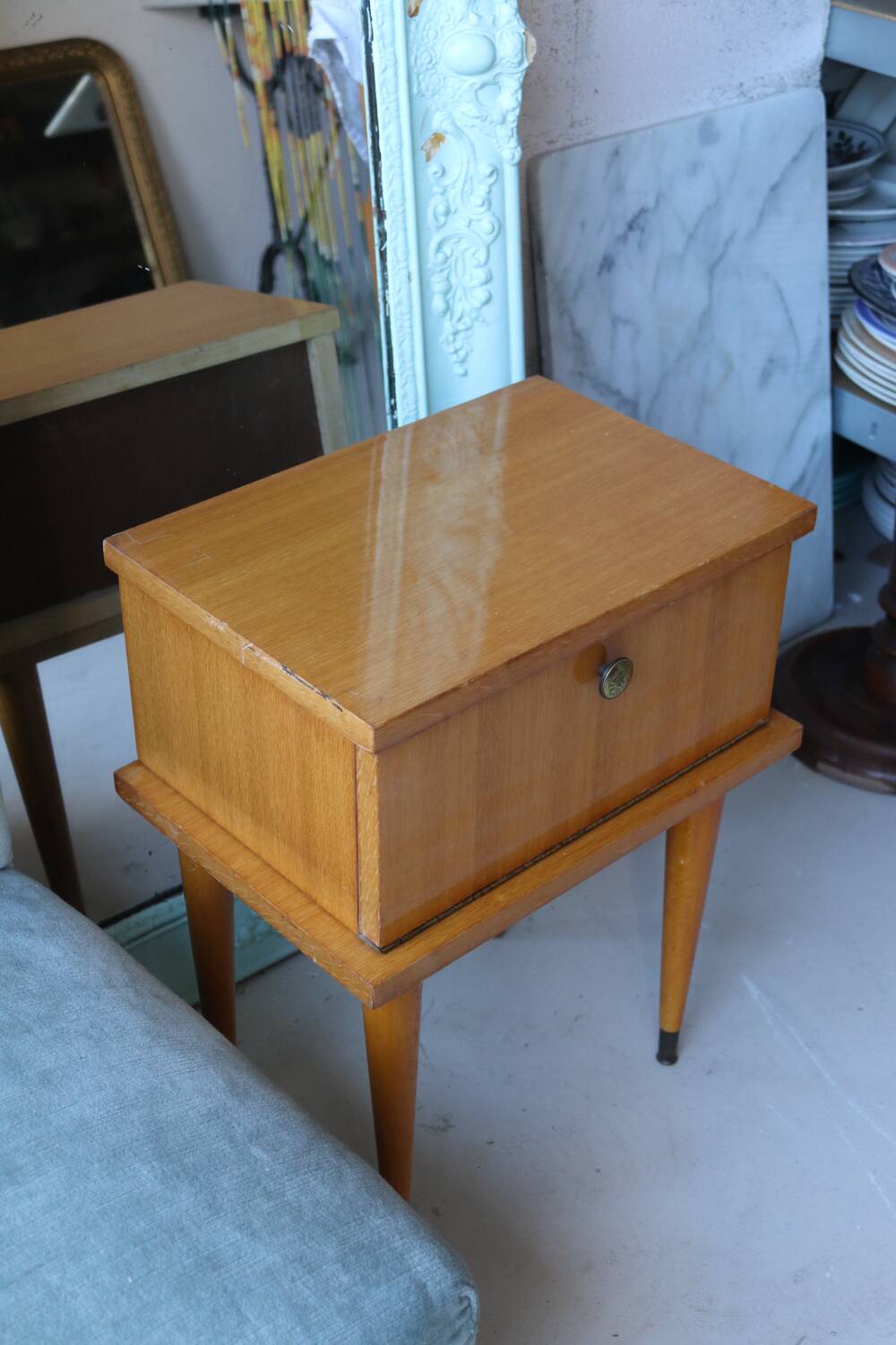 Modernist bedside table from the 1950s with compass legs.