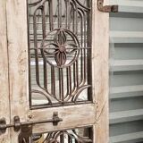 Chiseled teak door with openwork wrought iron panels