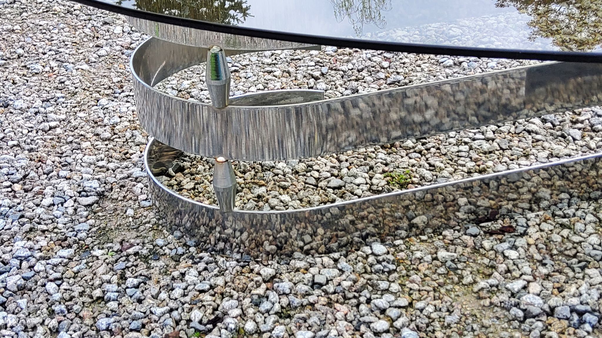 Oval coffee table of the 70s chromed metal base in s smoked glass top