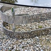 Oval coffee table of the 70s chromed metal base in s smoked glass top