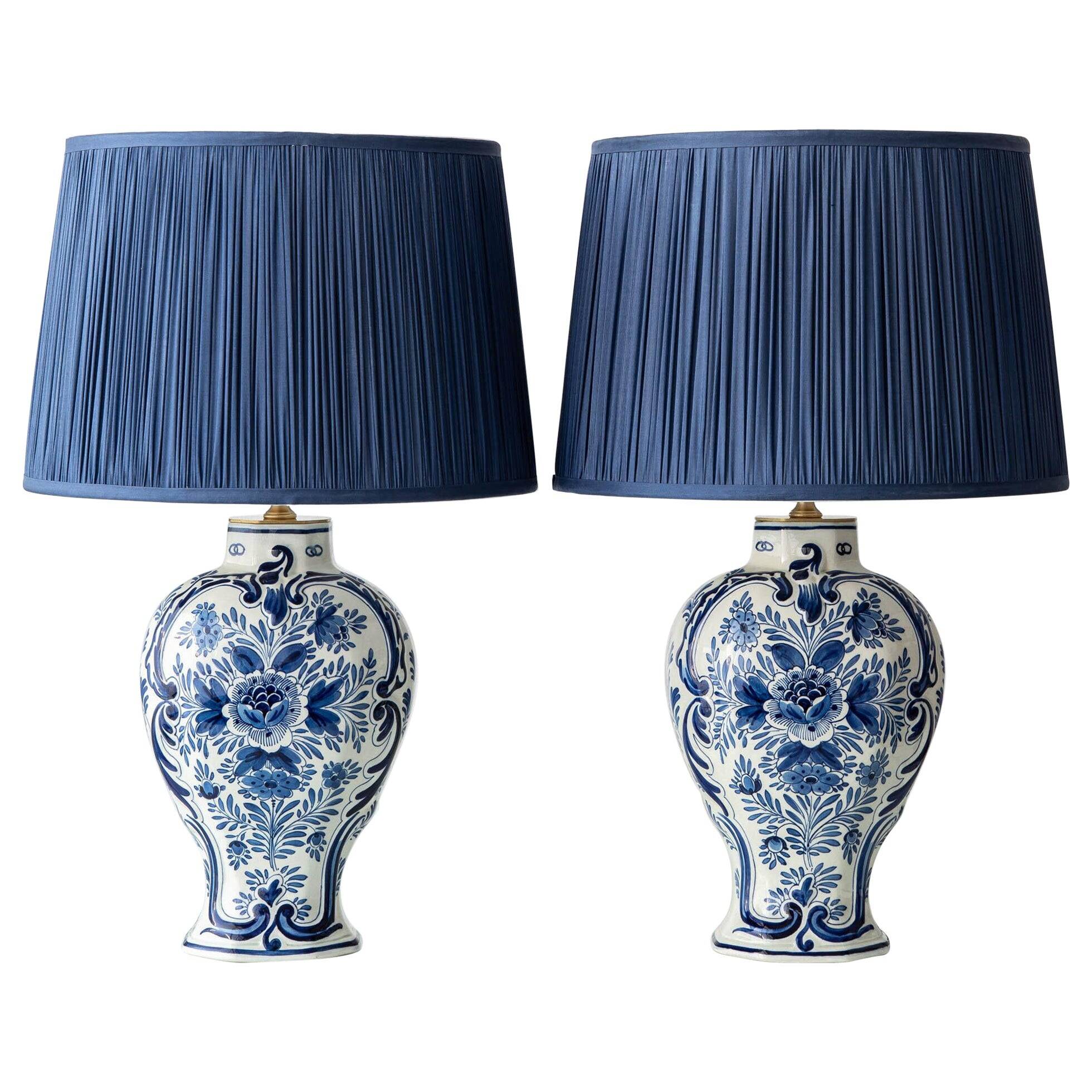Pair of Royal Delft blue and white ceramic table lamps, 1905, with new pleated silk shades.