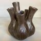 Tulip vase with ceramic flowers in brown and gold.