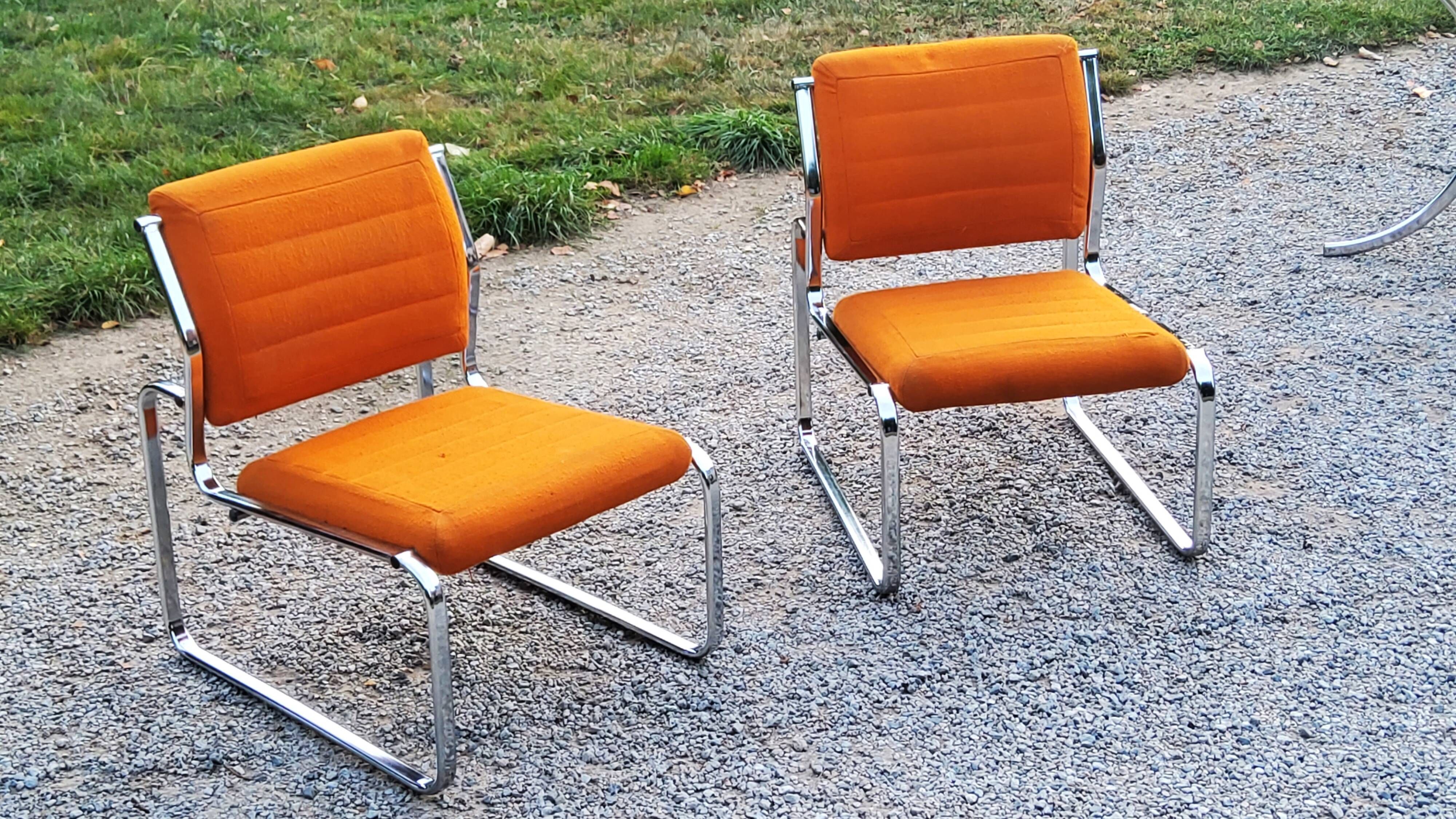 Pair of designer armchairs in orange fabrics and chrome tubes from the 70s