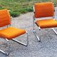 Pair of designer armchairs in orange fabrics and chrome tubes from the 70s