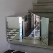 Triptych mirror with eglomisé and pediment, 1940s-50s