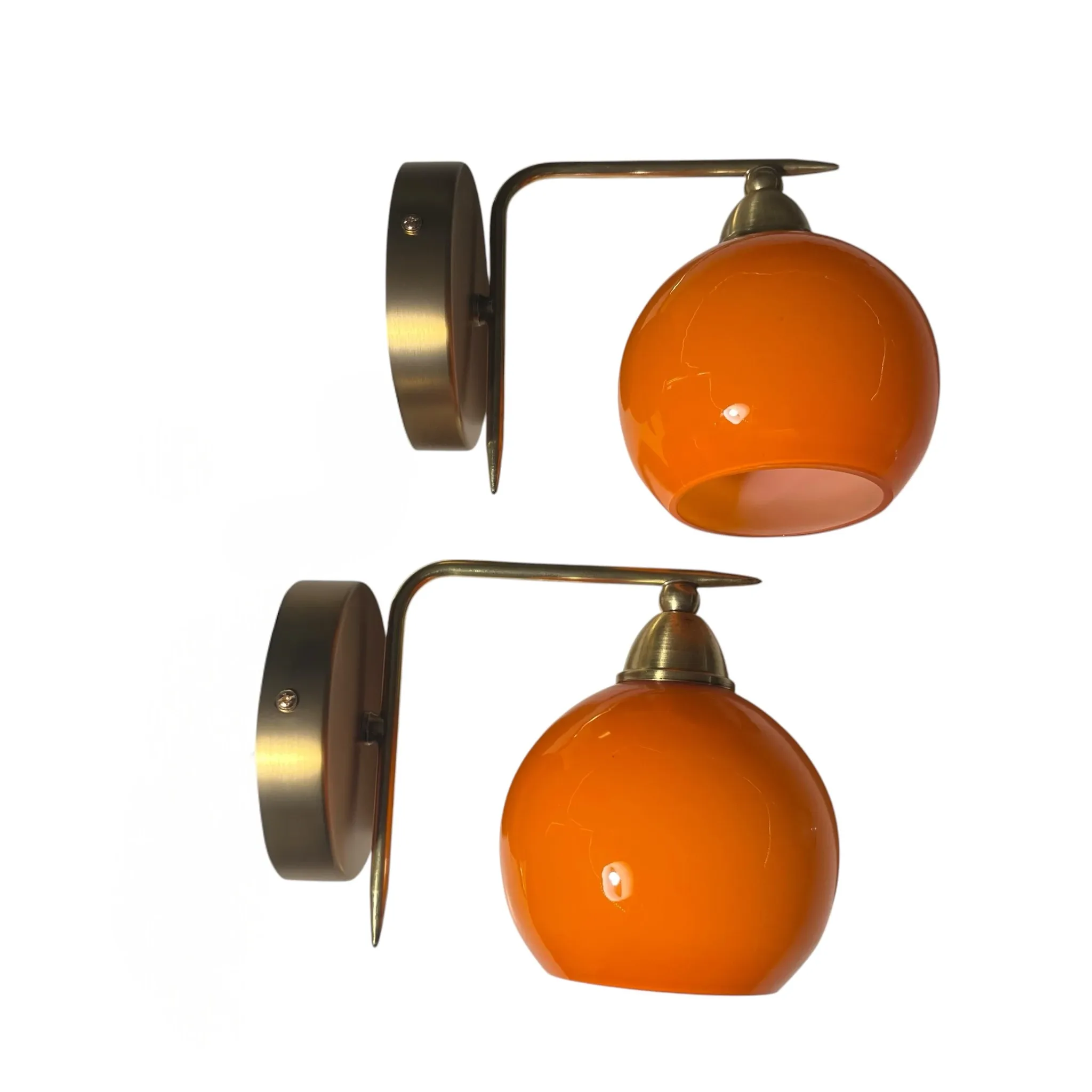 Pair of wall sconces with orange opaline glass globes and brass.